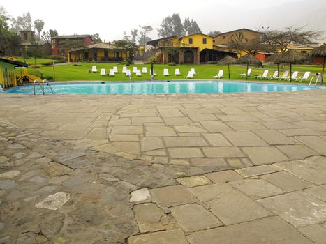 Swimming pool area of hotel with umbrella and beach chair Lima-Peru