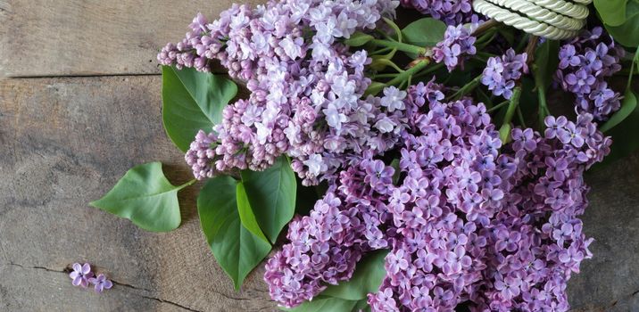 Beautiful spring flowers lilac on old grunge wooden background, Bunch of pastel colour lilac, flat lay, top view