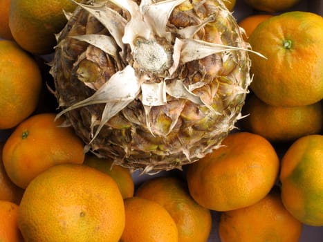 Fresh pineapple & tangerine fruit collection closeup