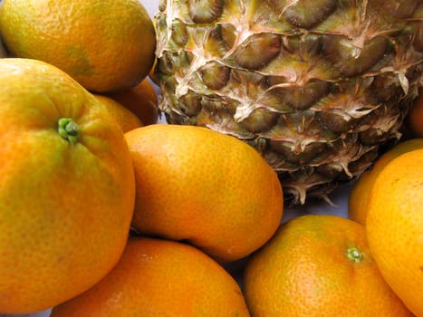 Fresh pineapple & tangerine fruit collection closeup