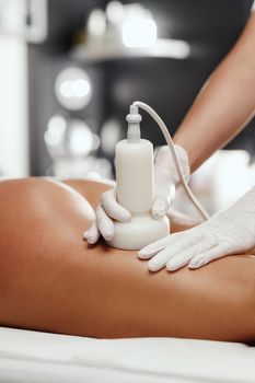 Shot of an unrecognizable woman getting anti cellulite massage at the beauty salon. She have an ultrasound cavitacion treatment to fat reduction.