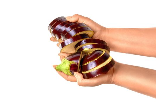 Human hand holding ripe sliced eggplant isolated on white background in studio. Healthy food and diet