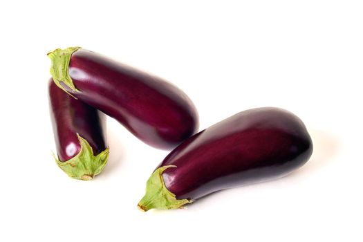 Three eggplants with a green sepal. Isolate on white background