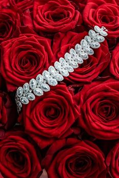 Gemstone jewellery, wedding fashion and luxe shopping concept - Luxury diamond bracelet and bouquet of red roses, jewelry love gift on Valentines Day and romantic holidays present