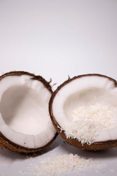 opened coconut with coconut flakes isolated on white background. tropical, nut.