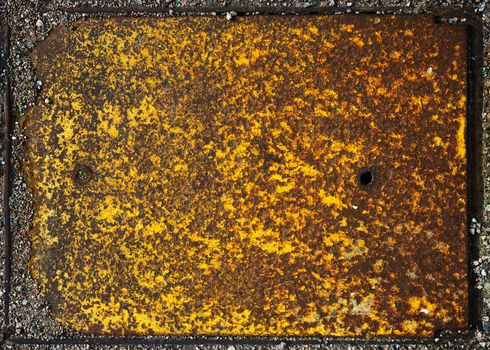 The rust covered surface is yellow, orange and brown, and highly weathered.