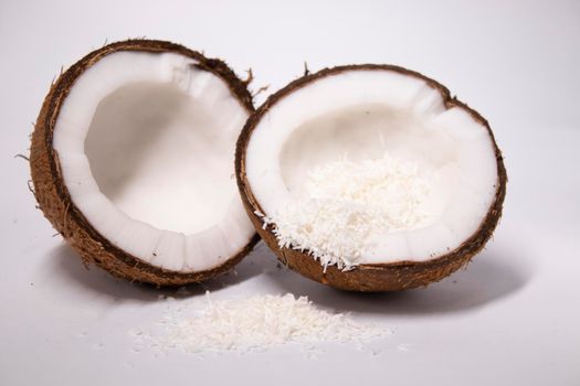 opened coconut with coconut flakes isolated on white background. tropical, nut.