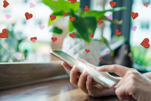 Hand typing love letter email in smartphone social network online community  with social media love letter mail send out icons valentine concept.