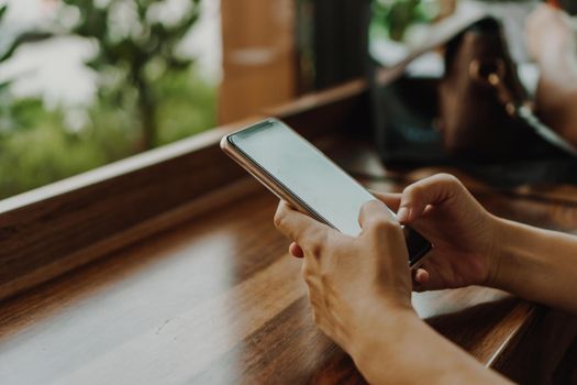 Woman hand using smartphone to do work business, social network, communication concept.