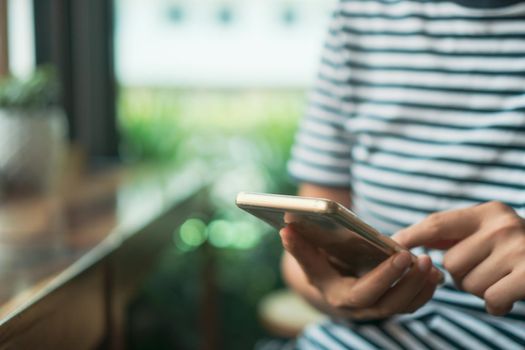 Woman hand using smartphone to do work business, social network, communication concept.