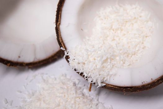 opened coconut with coconut flakes isolated on white background. tropical, nut.