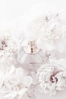 Chic fragrance bottle as luxe perfume product on background of peony flowers, parfum ad and beauty branding design