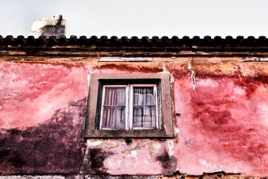 Old and colorful damaged facade in Lisbon
