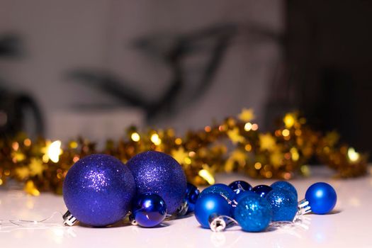 blue Christmas ball toys on a background of golden bokeh. new year theme. High quality photo