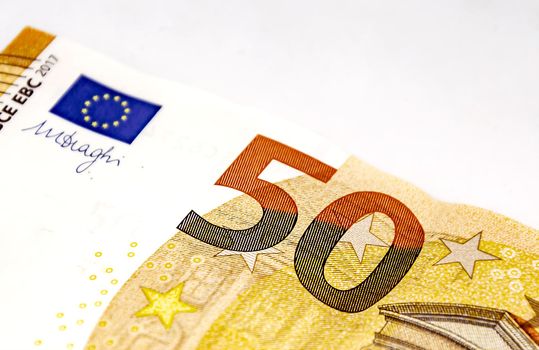 Detail of a 50 euro banknote isolated on a white background. European Union currency. Economics and finance. Paper cash. Copy space