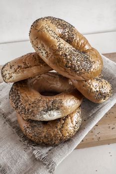 Some delicious bagels with poppy seeds on a napkin close-up. Front view.