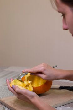 the process of making a Halloween pumpkin. cleansing of seeds. horror theme and Hallowe'en.