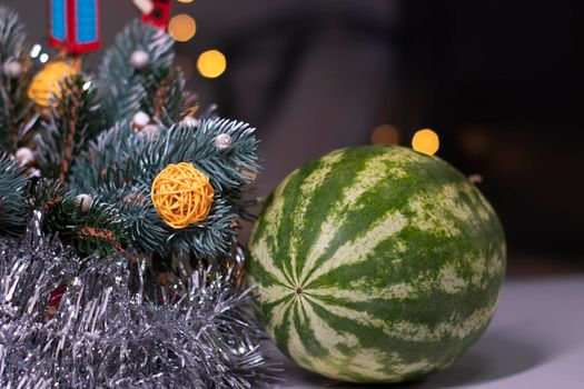 watermelon next to new year decorations. christmas theme.