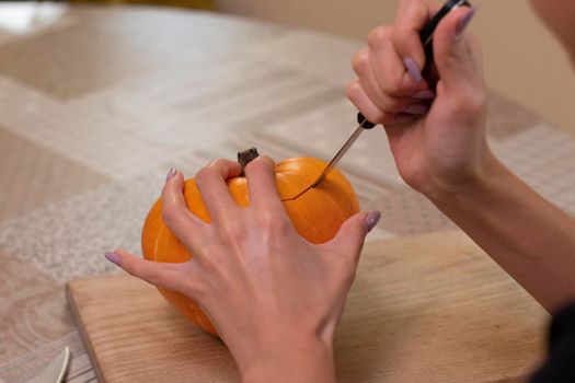 the process of making a Halloween pumpkin. horror theme and Hallowe'en.