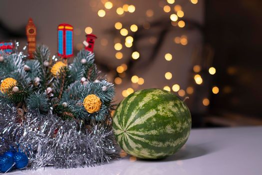 watermelon next to new year decorations. christmas theme.