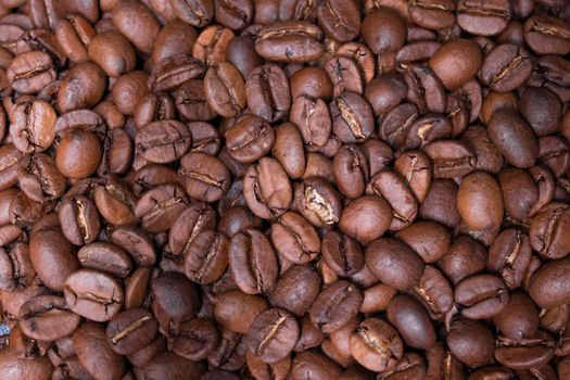 close up Freshly roasted coffee beans background. top view.