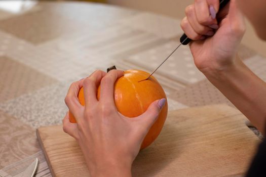 the process of making a Halloween pumpkin. horror theme and Hallowe'en.