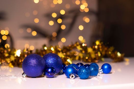 blue Christmas ball toys on a background of golden bokeh. new year theme. High quality photo