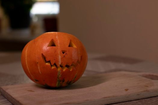 Halloween pumpkin in the dark with lighted candle inside. horror theme and Hallowe'en.