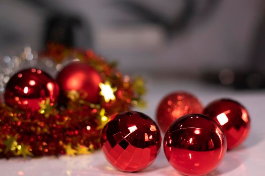 red Christmas ball toy on a background of golden bokeh. new year theme.