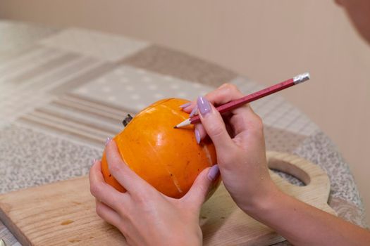 the process of making a Halloween pumpkin. drawing a layout. horror theme and Hallowe'en.