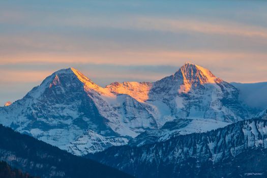 Stuuning view of Eiger North Face and Monch in Sunset from the lake side of the Thun lake, Canton of Bern, Switzerland