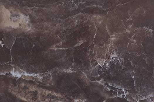 Brown marble background. Elegant dark brown marble with veins close up. Granite with natural pattern