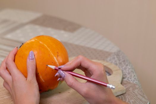 the process of making a Halloween pumpkin. drawing a layout. horror theme and Hallowe'en.