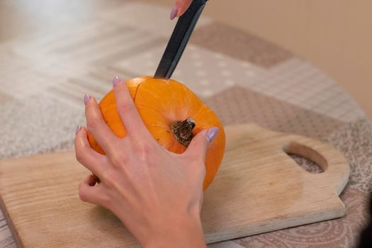 the process of making a Halloween pumpkin. horror theme and Hallowe'en.