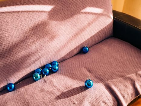 Blue christmas balls for a christmas tree on the couch.