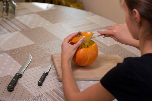 the process of making a Halloween pumpkin. cleansing of seeds. horror theme and Hallowe'en.