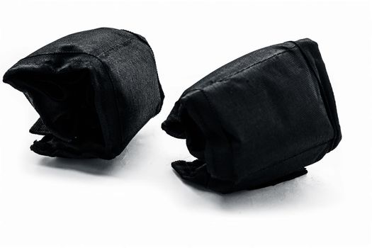 Black colored ankle weights isolated on white.