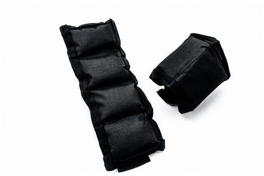 Black colored ankle weights isolated on white.