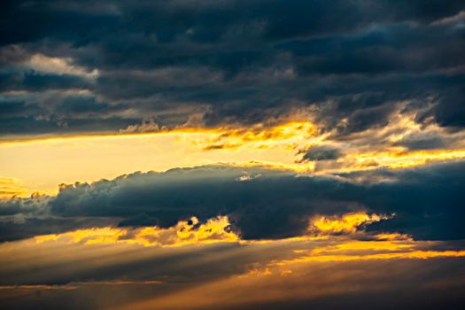 The heavenly light of the sun.Dramatic evening sky with clouds and rays of the sun.Sunlight at evening sunset or morning dawn.Panoramic view of the blue sky with clouds in motion.Heaven sunset