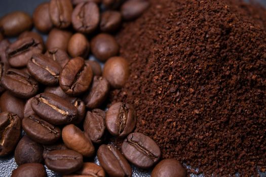 pile of ground or instant coffee and roasted coffee beans seeds. background.