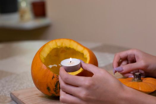 the process of making a Halloween pumpkin. lighted candle. horror theme and Hallowe'en.