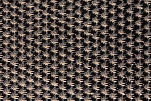 texture and background of used dusty cellular rubber floor mat - aligned perspective view