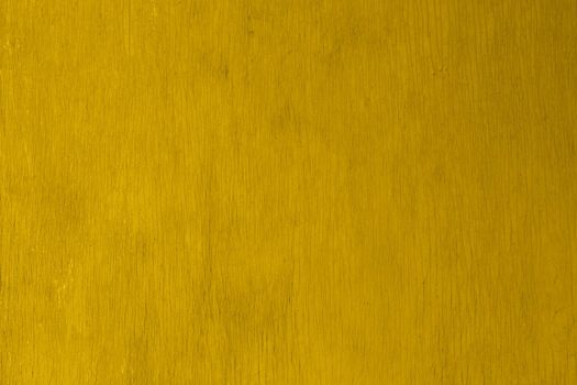 old yellow painted plywood flat surface texture and background with even vertical cracks