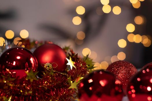 red Christmas ball toy on a background of golden bokeh. new year theme.