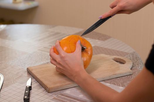 the process of making a Halloween pumpkin. horror theme and Hallowe'en.