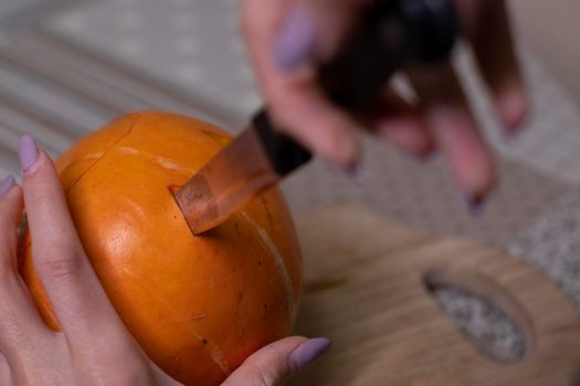 the process of making a Halloween pumpkin. cutting out eyes. horror theme and Hallowe'en.