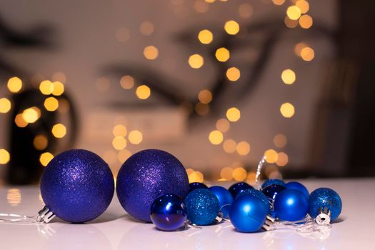 blue Christmas ball toys on a background of golden bokeh. new year theme. High quality photo