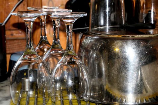 Glasses, cutlery and cooking pot drying next to the sink in the kitchen