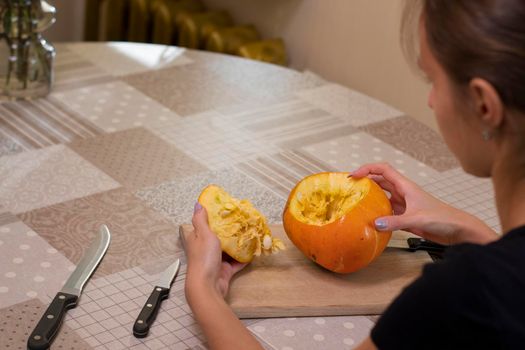 the process of making a Halloween pumpkin. cleansing of seeds. horror theme and Hallowe'en.