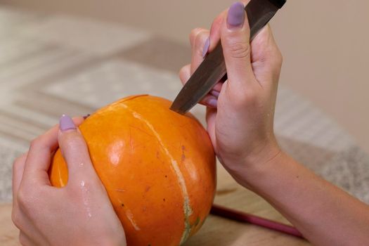 the process of making a Halloween pumpkin. horror theme and Hallowe'en.